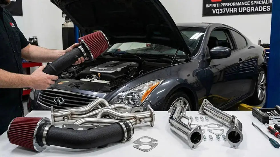 Infiniti G37 bolt-on performance mods installation showing mechanic with cold air intakes, exhaust headers, and test pipes in a performance shop.